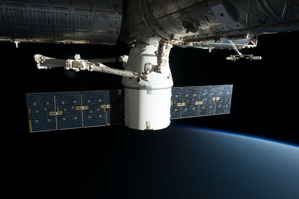 A large satellite stationed above earth, improving the efficiency and productivity of a company's Back-Office, CRM and ERP Systems